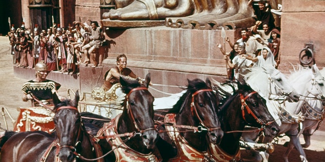American actor Charlton Heston (1923-2008) as Judah Ben-Hur in the chariot racing scene from "Ben-Hur," directed by William Wyler, 1959. 