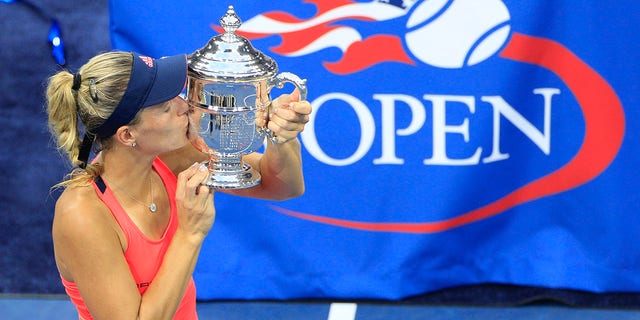 Angelique Kerber, of Germany, celebrates with the trophy after her win against Karolina Pliskova, of the Czech Republic, in the Women's Singles Final on Arthur Ashe Stadium on day thirteen of the 2016 U.S. Open Tennis Tournament at the USTA Billie Jean King National Tennis Center on September 10, 2016 in Flushing, Queens, New York City.  