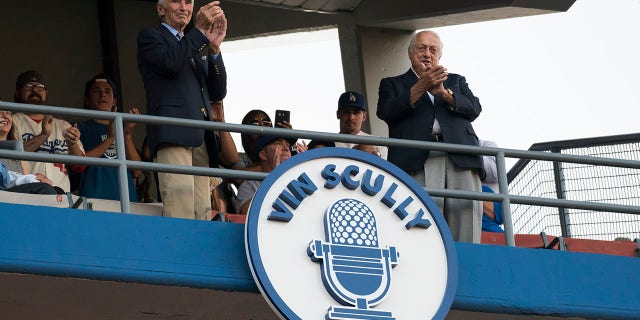 Hall of Famer Sandy Koufax and former Dodger Manager Tom Lasorda unveil the Vin Scully plaque in the Dodgers' Ring of Honor before an MLB game between the San Francisco Giants and the Los Angeles Dodgers on May 3, 2017, at Dodger Stadium in Los Angeles, CA.