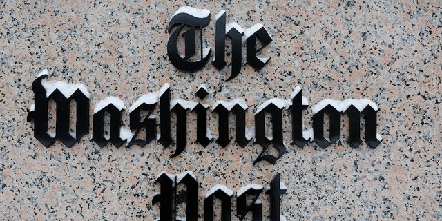 Washington Post logo outside of the building covered with snow.