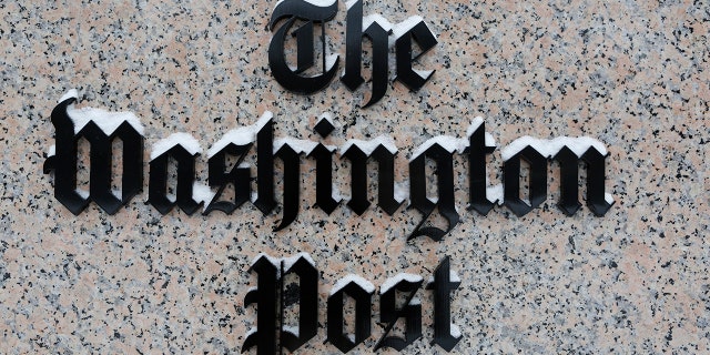 Washington Post logo outside of the building covered with snow.