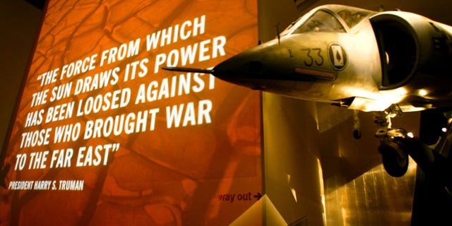 A U.S. Marine Corps Harrier Jump Jet hangs in front of an audio-visual display inside the Imperial War Museum North in Manchester, England.