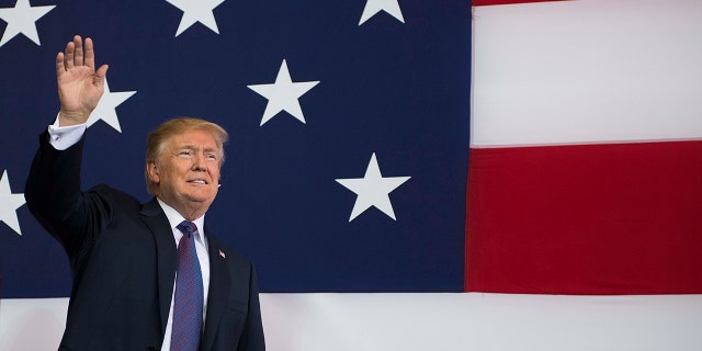 President Donald Trump waves as he arrives to speak to US military personnel at Yokota Air Base at Fussa in Tokyo on November 5, 2017.