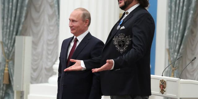 Russian President Vladimir Putin (L) poses with Russian pop singer Philip Kirkorov during a state awards ceremony in the Moscow Kremlin on November 15, 2017.