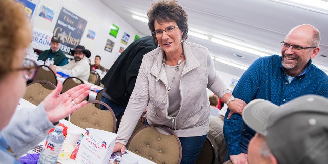 Rep. Jackie Walorski, R-Ind., and her husband, Dean, talk with guests at the Kosciusko County Republican Fish Fry in Warsaw, Ind., on April 4, 2018. 