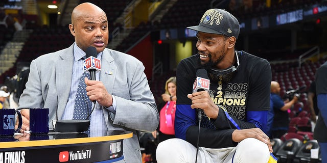 Kevin Durant, then of the Golden State Warriors, right, talks with Charles Barkley after Game Four of the 2018 NBA Finals against the Cleveland Cavaliers at Quicken Loans Arena in Cleveland, Ohio, on June 8, 2018.