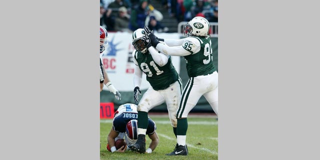 New York Jets' Josh Evans (91) and Steve White (95) celebrate after sacking Buffalo Bills' Drew Bledsoe in second quarter of game at Giants Stadium. The Jets defeated the Bills, 31-13, for their fourth straight victory.