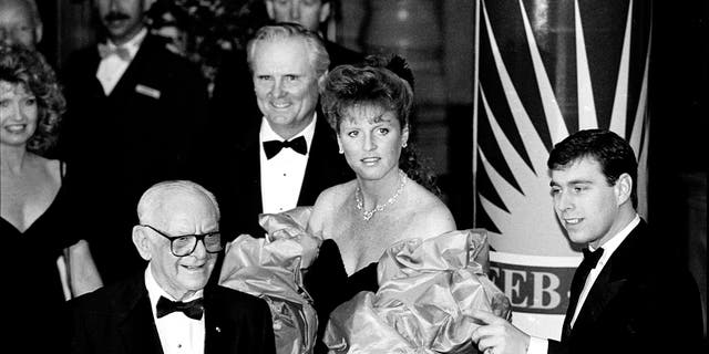 Sarah, Duchess of York, and her then-husband, Prince Andrew, are joined by American businessmen Armand Hammer, foreground, left, and Lodwrick Cook, rear, center, on Feb. 28, 1988, Los Angeles, California.
