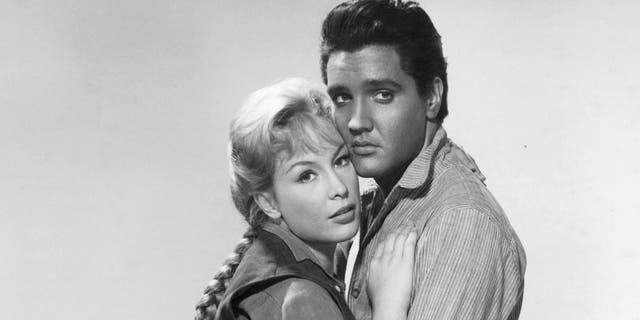 Barbara Eden is held by Elvis Presley in publicity portrait for the film "Flaming Star," 1960.
