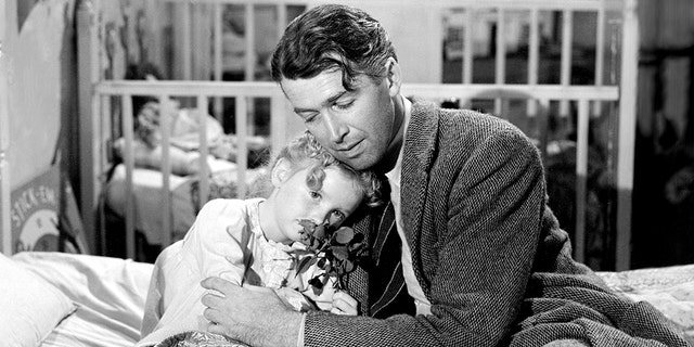 James Stewart (1908-1997), as George Bailey, and Karolyn Grimes as his daughter Zuzu, in a scene from "It's a Wonderful Life," directed by Frank Capra, 1946. Grimes told Fox News Digital "another bell has rung" in response to Virginia Patton's passing.