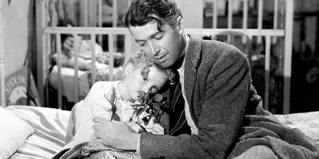 James Stewart (1908-1997), as George Bailey, and Karolyn Grimes as his daughter Zuzu, in a scene from "It's a Wonderful Life," directed by Frank Capra, 1946. Grimes told Fox News Digital "another bell has rung" in response to Virginia Patton's passing.