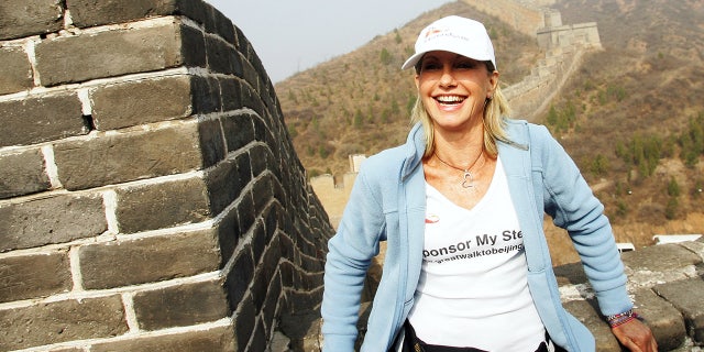 LUAOlivia Newton-John poses before beginning the 21-day ‘Great Walk to Beijing 2008’ trek along The Great Walk of China to raise money and awareness for the Olivia Newton-John Cancer Centre, at the Jinshanling Great Wall on April 7, 2008, in Luanping of Hebei province, China.