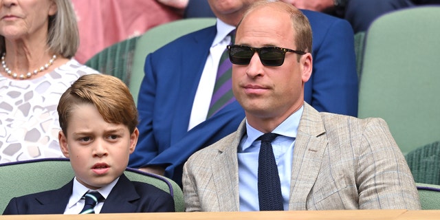 Prince George, seen here with his father Prince William, is third in line to the British throne.