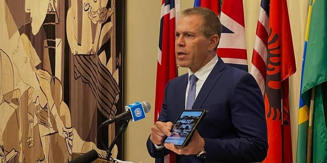 The Israeli ambassador to the UN, Gilad Erdan, addresses the press outside the Security Council room. 