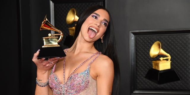 Dua Lipa, winner of the 2021 Grammy for Best Pop Vocal Album for "Future Nostalgia," poses in the media room during the 63rd Annual GRAMMY Awards at Los Angeles Convention Center. The shape of the award for music excellence was inspired by Thomas Edison's phonograph.