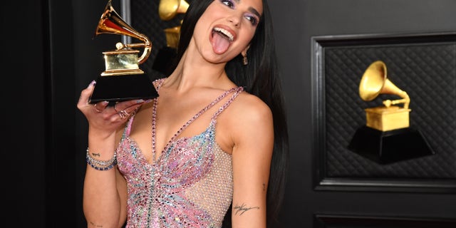 Dua Lipa, winner of the 2021 Grammy for Best Pop Vocal Album for "Future Nostalgia," poses in the media room during the 63rd Annual GRAMMY Awards at Los Angeles Convention Center. The shape of the award for music excellence was inspired by Thomas Edison's phonograph.