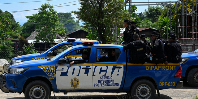 Guatemalan Civil National Police are seen patrolling the El Estor indigenous municipality in October 2021.