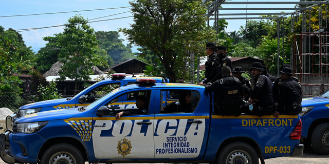 Guatemalan Civil National Police are seen patrolling the El Estor indigenous municipality in October 2021.