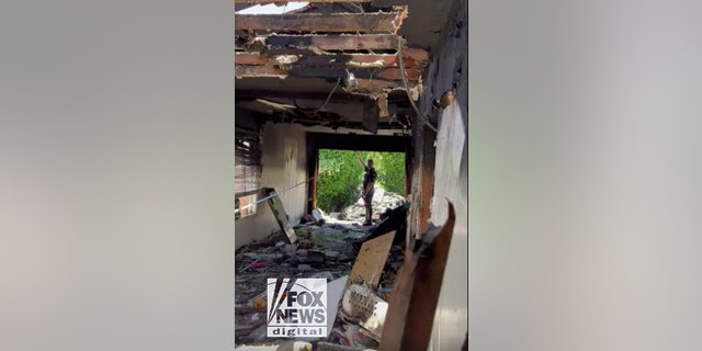 Anne Heche car crash scene footage released: Inside the damaged LA home 2 An LAPD officer stands in what was once the doorway to Lynne Mishele's home after Anne Heche crashed her car into the house on August 5.