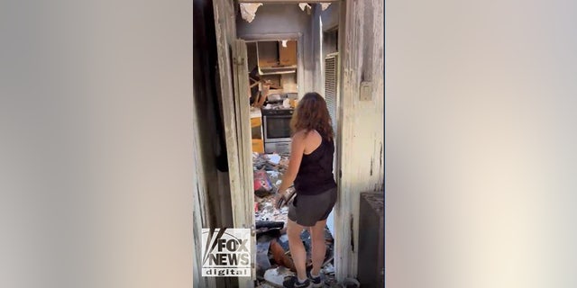Anne Heche car crash scene footage released: Inside the damaged LA home 6 A friend of Lynne Mishele helps her look through what remains of her belongings from the fire.