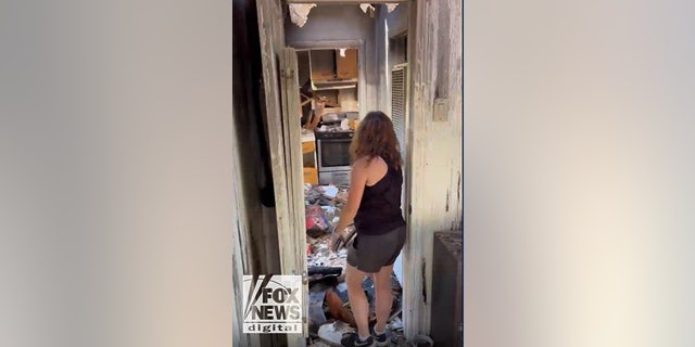 A friend of Lynne Mishele's helps her look through what's left of her possessions from the fire.