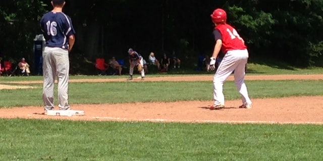 A high school baseball player is pictured here.Older children should