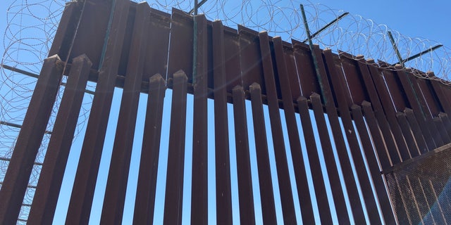 Razor wire lays along the Trump-era border wall and is also going to be on the shipping containers Arizona's governor ordered to be put in Yuma.