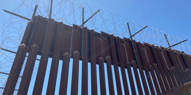 Razor wire lays along the Trump-era border wall and is also going to be on the shipping containers Arizona's governor ordered to be put in Yuma.