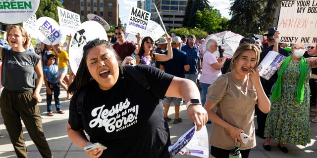 FILE - Rebeca Castro of Fruitland sings and dances to a Christian praise song during an anti-abortion celebration for the overturn of Roe v. Wade, held outside of the Idaho Statehouse in Boise, Idaho on Tuesday, June 28, 2022.