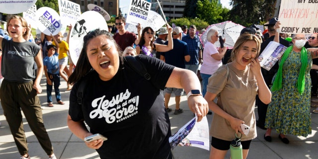 FILE - Rebeca Castro of Fruitland sings and dances to a Christian praise song during an anti-abortion celebration for the overturn of Roe v. Wade, held outside of the Idaho Statehouse in Boise, Idaho on Tuesday, June 28, 2022.