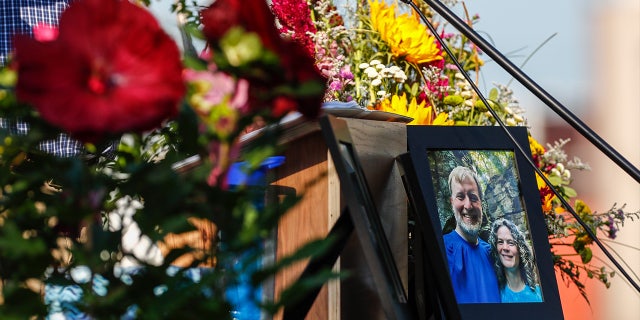 A photo of Tyler and Sarah Schmidt sits on the podium during the Celebration of Life event for Tyler, Sarah, and Lula Schmidt held at Overman Park on Tuesday, Aug. 2 2022 in Cedar Falls, Iowa.