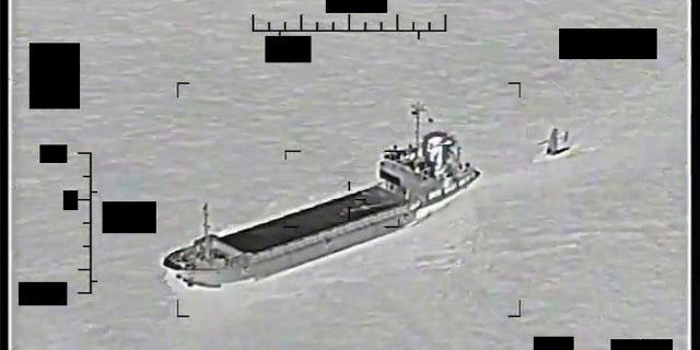 This photo released by the U.S. Navy shows Iranian Revolutionary Guard Corps Shahid Bazar (left) towing a U.S. Navy Sail Drone Explorer in the Persian Gulf on Tuesday, Aug. 30, 2022. 