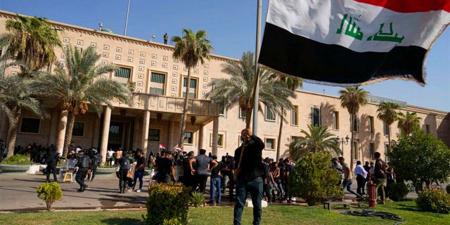 Supporters of Shiite cleric Muqtada al-Sadr demonstrate in the grounds of the Government Palace in Baghdad, Iraq, Monday, Aug. 29, 2022.