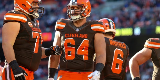 Cleveland Browns guard Joel Bitonio, left, and center JC Tretter regroup during a game against the Atlanta Falcons at FirstEnergy Stadium in Cleveland, Ohio, on Nov. 11, 2018.