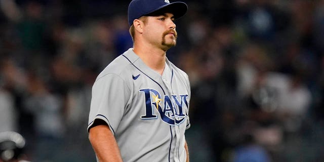 Tampa Bay Rays relief pitcher Jalen Beeks reacts as New York Yankees' Josh Donaldson runs the bases after hitting a walk-off grand slam during the 10th inning of a baseball game Wednesday, Aug. 17, 2022, in New York. The Yankees won 8-7.