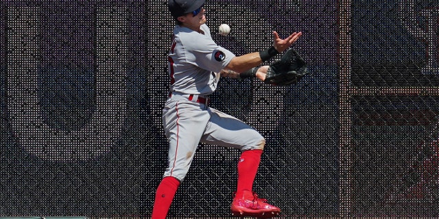 Boston Red Sox center fielder Jaren Duran, #40, is unable to make a catch near the wall in the eighth inning against the Kansas City Royals at Kauffman Stadium on August 7, 2022 in Kansas City, Missouri.
