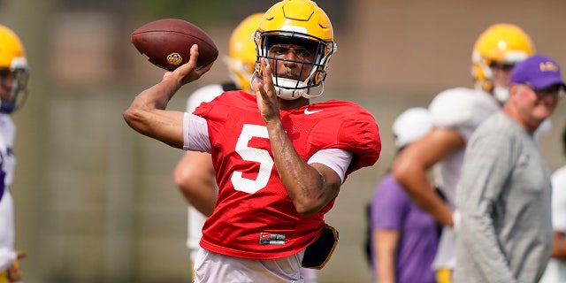 LSU quarterback Jayden Daniels (5) throws a pass during NCAA college football practice in Baton Rouge, La., Wednesday, Aug. 17, 2022.
