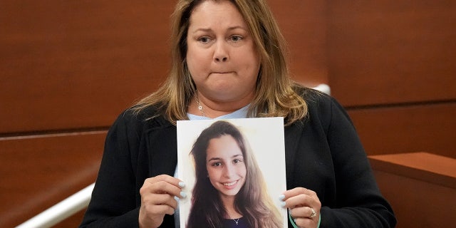 Jennifer Montalto holds a picture of her daughter, Gina, before giving her victim impact statement during the penalty phase of the trial of Marjory Stoneman Douglas High School shooter Nikolas Cruz at the Broward County Courthouse in Fort Lauderdale, Florida.