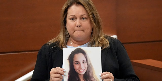 Jennifer Montalto holds a picture of her daughter, Gina, before giving her victim impact statement during the penalty phase of the trial of Marjory Stoneman Douglas High School shooter Nikolas Cruz at the Broward County Courthouse in Fort Lauderdale, Florida.