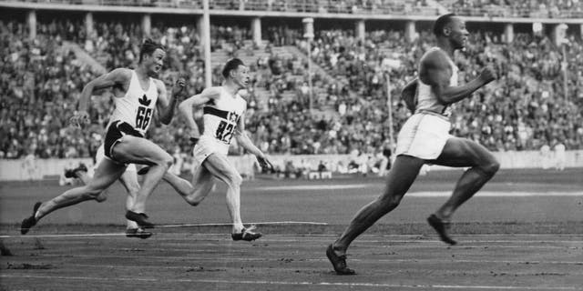 American Jesse Owens running in the 200-meter sprint — a new Olympic record — in Berlin, August 4, 1936.