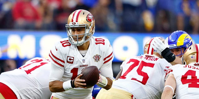 Jimmy Garoppolo (10) of the San Francisco 49ers looks to hand off the ball against the Los Angeles Rams in the NFC Championship Game at SoFi Stadium in Inglewood, California, on Jan. 30, 2022.