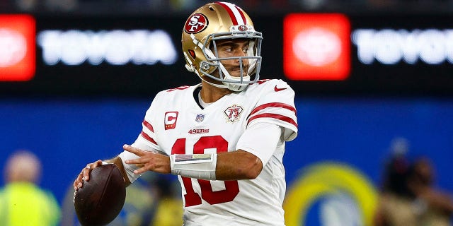 Jimmy Garoppolo (10) of the San Francisco 49ers looks to pass the ball against the Los Angeles Rams in the NFC Championship Game at SoFi Stadium in Inglewood, California, on Jan. 30, 2022.