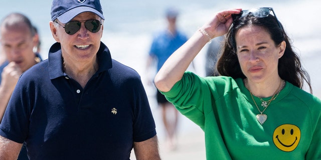 President Biden walks on the beach with his daughter Ashley Biden (R) and members of his extended family in Rehoboth Beach, Delaware, June 20, 2022.