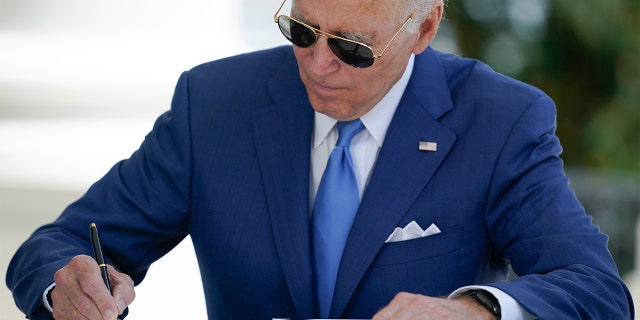 President Biden signs two bills aimed at combating fraud in the COVID-19 small business relief programs Friday, Aug. 5, 2022, at the White House in Washington.