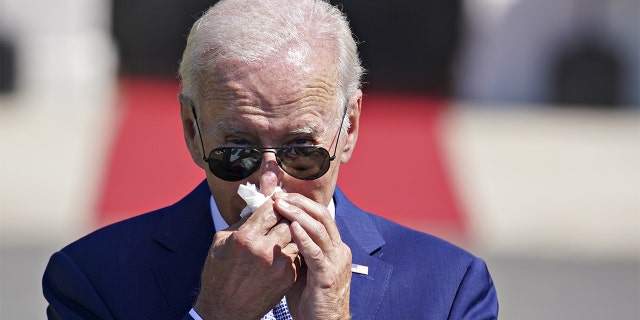 President Biden uses a tissue while speaking before signing HR 4346, the Chips and Science Act of 2022, during a ceremony on the South Lawn of the White House in Washington, DC, Tuesday, Aug. 9, 2022.