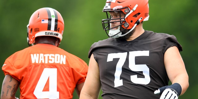 Joel Bitonio (75) and Deshaun Watson (4) of the Cleveland Browns warm up during the Browns mandatory minicamp at CrossCountry Mortgage Campus on June 14, 2022, in Berea, Ohio.