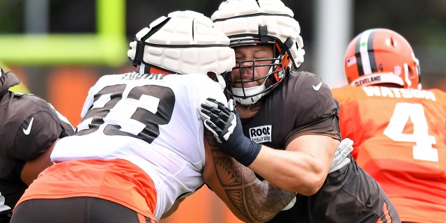 Joel Bitonio of the Cleveland Browns, center, blocks teammate Tommy Togiai (93) during Browns training camp at CrossCountry Mortgage Campus on Aug. 9, 2022, in Berea, Ohio.