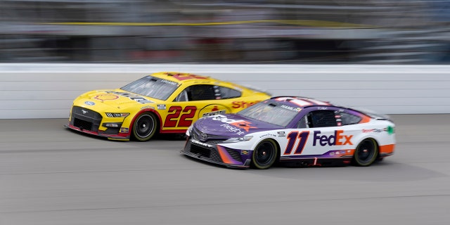 Denny Hamlin (11) and Joey Logano (22) race in the FireKeepers Casino 400 at Michigan International Speedway in Brooklyn, Michigan, Aug. 7, 2022.