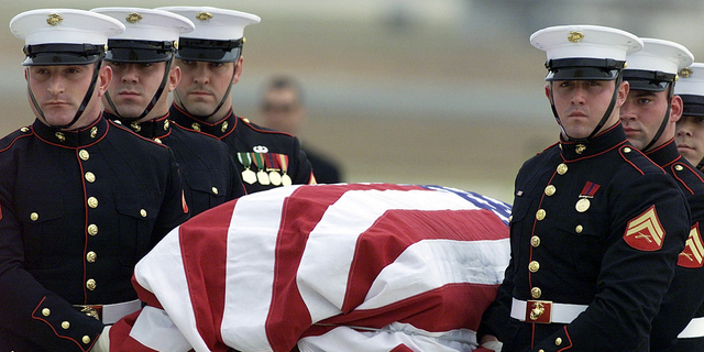 The body of CIA officer Johnny "Mike" Spann is carried by a Marine honor guard from an Air Force aircraft on Dec. 2, 2001 at Andrews Air Force Base