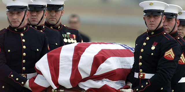 The body of CIA officer Johnny "Mike" Spann is carried by a Marine honor guard from an Air Force aircraft on Dec. 2, 2001 at Andrews Air Force Base